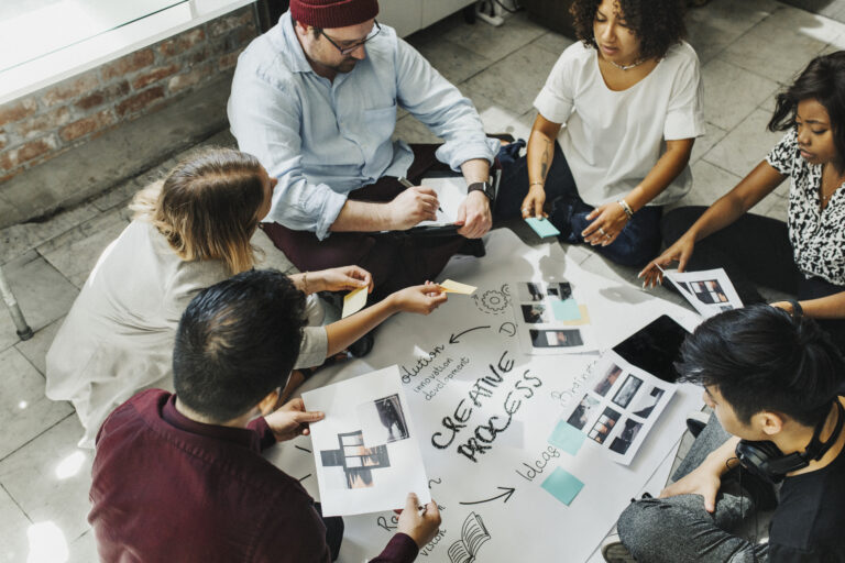 Business people brainstorming management process on paper